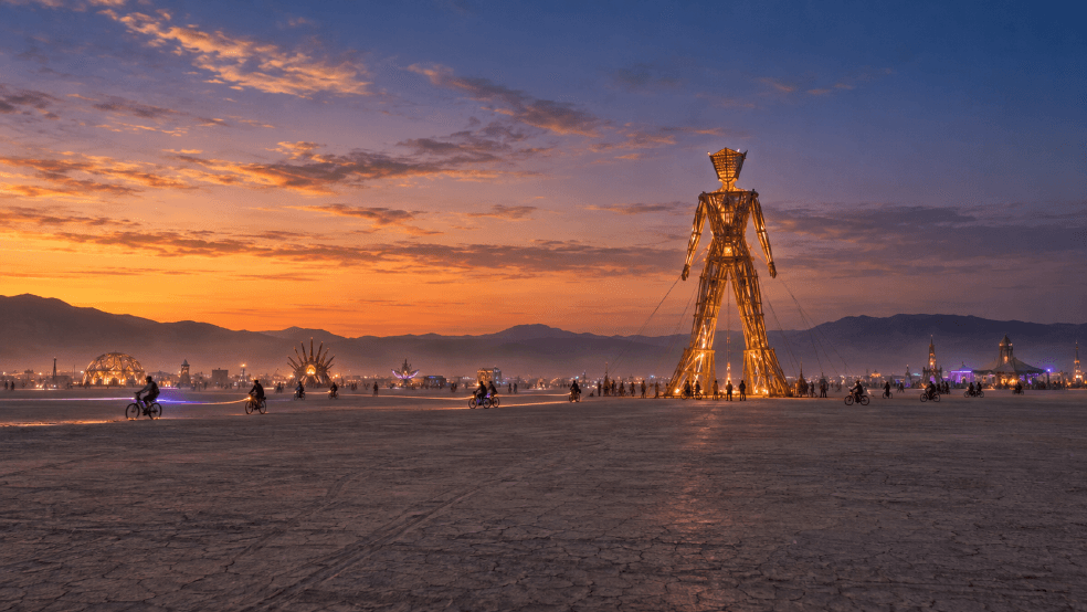 An AI-generated editorial illustration inspired by Black Rock City at sunset, used as a metaphor for temporary AI agent access and security controls.